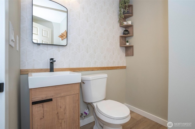 15512 Elm St E, Sumner, WA 98390 - bathroom featuring vanity, wood finished floors, and wallpapered walls
