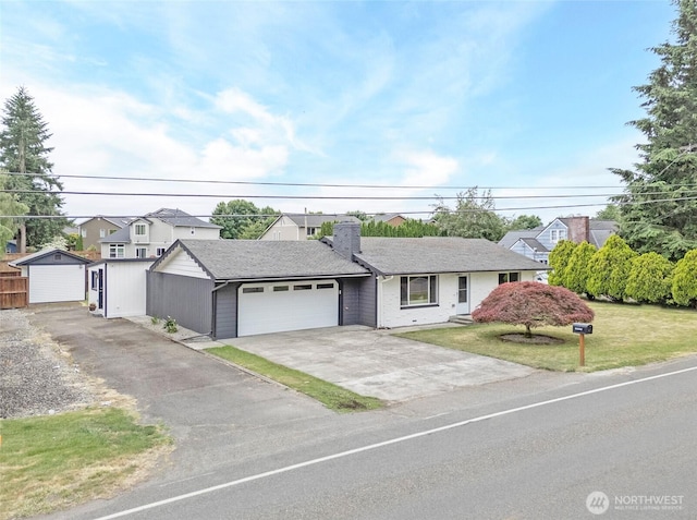 15512 Elm St E, Sumner, WA 98390 - view of front of house with a garage, concrete driveway, a chimney, a front lawn, and a residential view