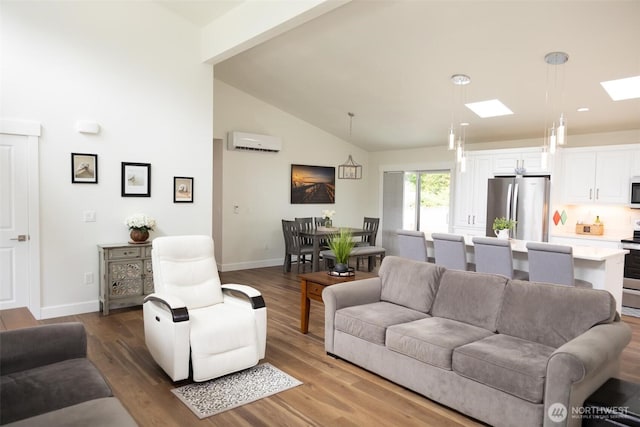 29813 L Ln, Ocean Park, WA 98640 - living room featuring an AC wall unit, a skylight, wood finished floors, and high vaulted ceiling