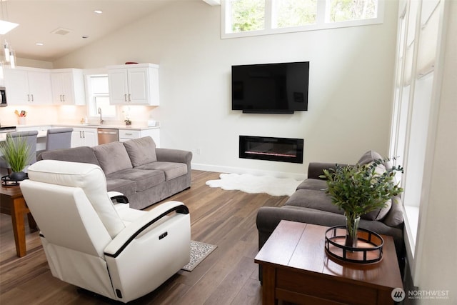 29813 L Ln, Ocean Park, WA 98640 - living area with vaulted ceiling, wood finished floors, a glass covered fireplace, and recessed lighting