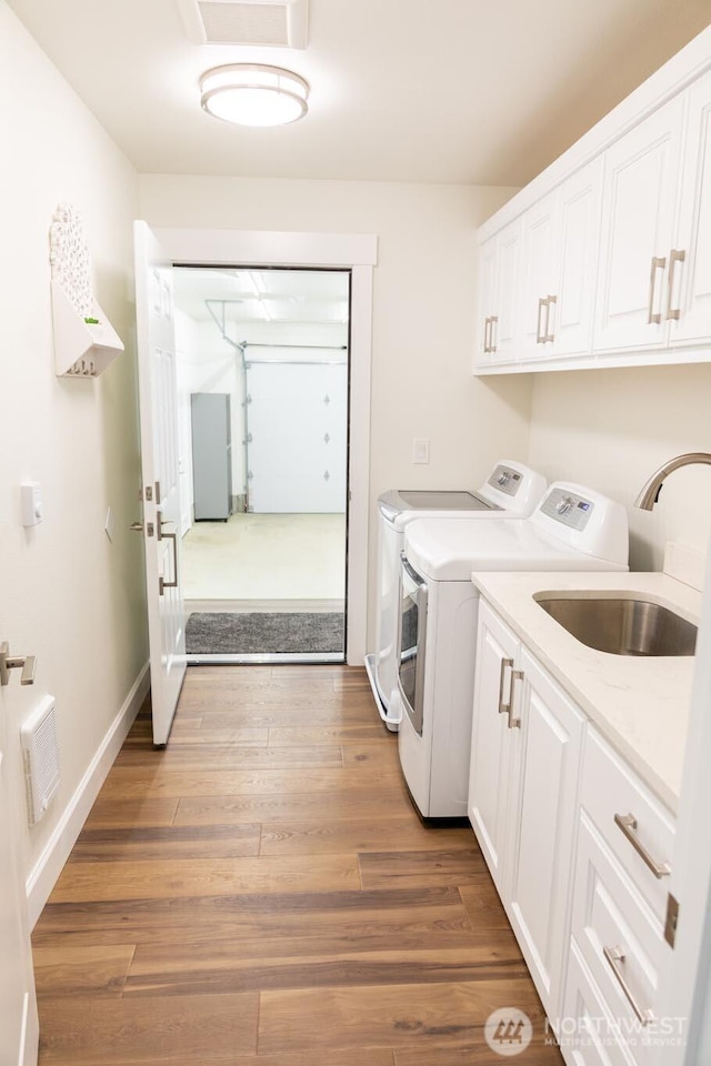 29813 L Ln, Ocean Park, WA 98640 - laundry room with washing machine and dryer, cabinet space, and wood finished floors