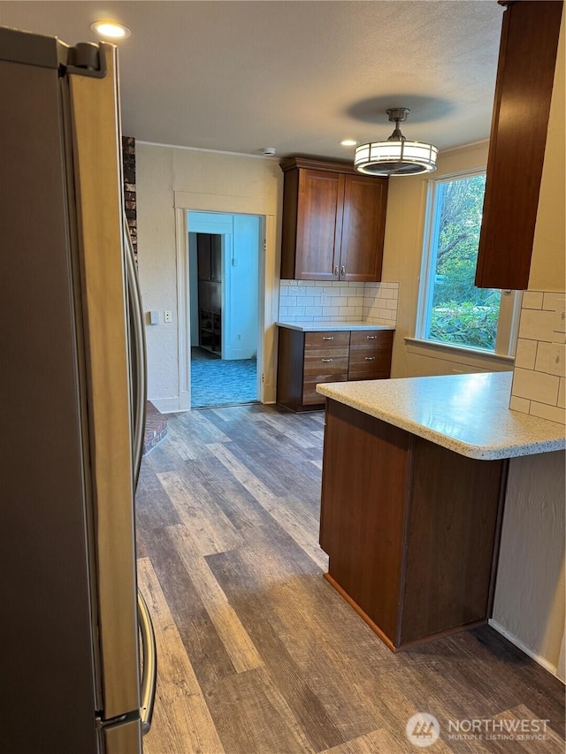 2520 Eureka Ave, Centralia, WA 98531 - kitchen featuring freestanding refrigerator, dark wood-style flooring, light countertops, tasteful backsplash, and a peninsula