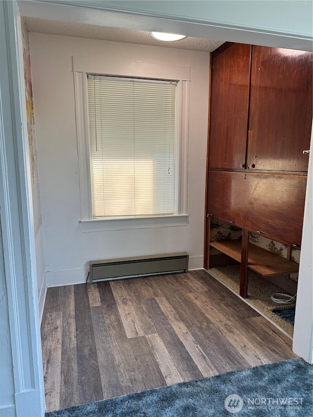 2520 Eureka Ave, Centralia, WA 98531 - unfurnished bedroom featuring a baseboard heating unit and wood finished floors
