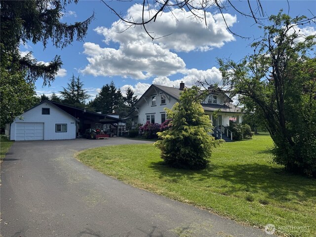 2520 Eureka Ave, Centralia, WA 98531 - view of front facade featuring a front yard, asphalt driveway, a detached garage, and a chimney