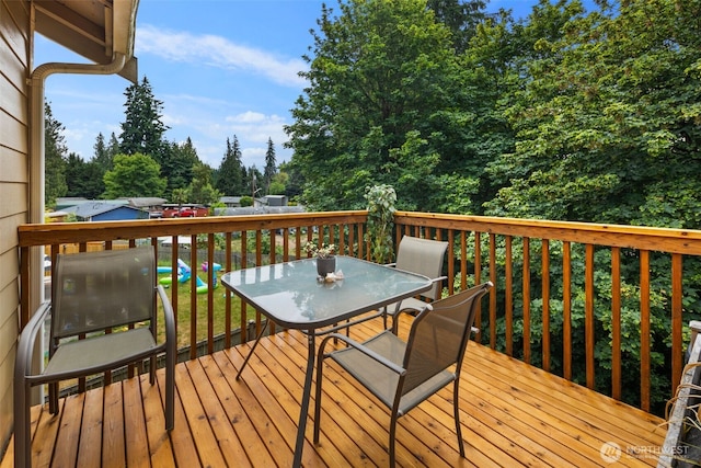 5542 55th Loop SE, Olympia, WA 98513 - wooden deck featuring outdoor dining area and view of scattered trees