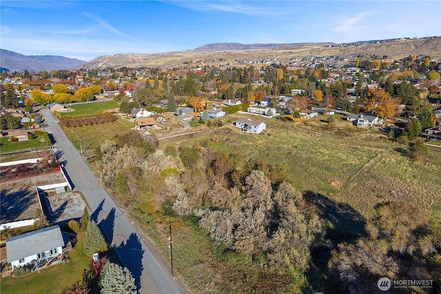 2599 NW Columbia Ave, East Wenatchee, WA 98802 - aerial overview of property's location with a mountainous background and nearby suburban area