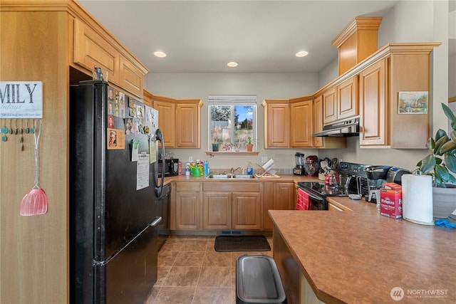2599 NW Columbia Ave, East Wenatchee, WA 98802 - kitchen with black appliances, under cabinet range hood, light tile patterned floors, recessed lighting, and light countertops