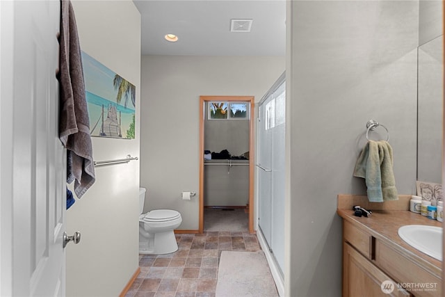 2599 NW Columbia Ave, East Wenatchee, WA 98802 - bathroom featuring vanity, stone finish flooring, and recessed lighting