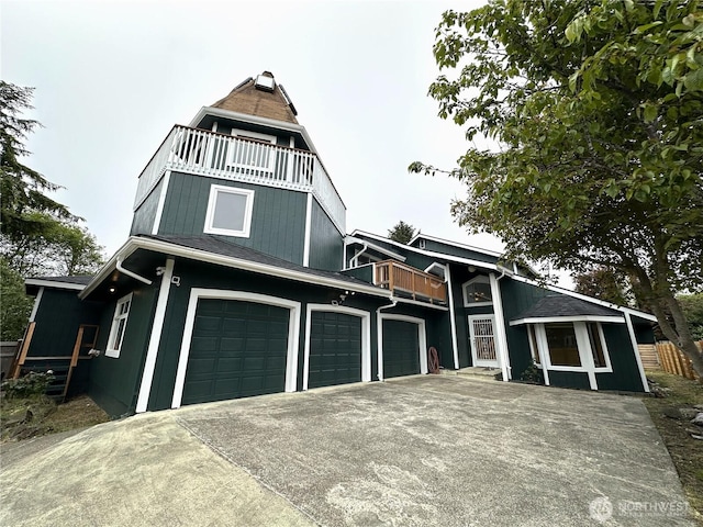 832 Whale Ct SW, Ocean Shores, WA 98569 - view of front facade with a balcony, an attached garage, and driveway