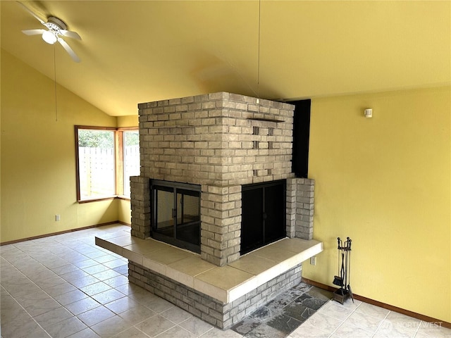 832 Whale Ct SW, Ocean Shores, WA 98569 - unfurnished living room featuring a brick fireplace, vaulted ceiling, a ceiling fan, and tile patterned floors