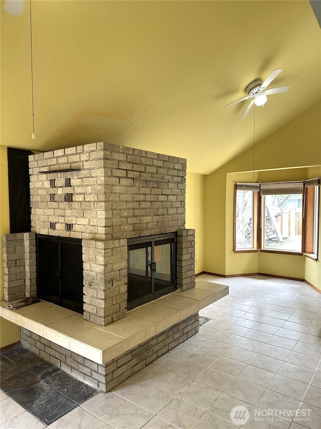 832 Whale Ct SW, Ocean Shores, WA 98569 - unfurnished living room with a brick fireplace, ceiling fan, and lofted ceiling