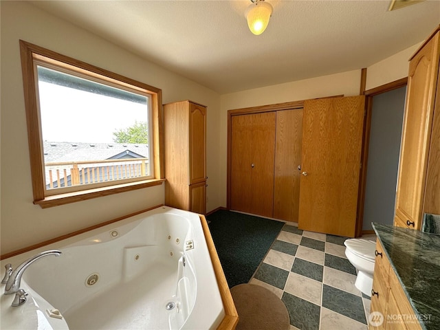 832 Whale Ct SW, Ocean Shores, WA 98569 - bathroom featuring a whirlpool tub, vanity, and tile patterned floors