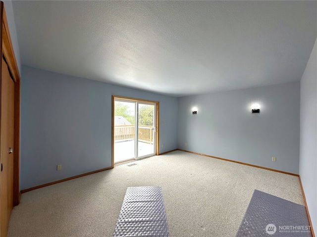832 Whale Ct SW, Ocean Shores, WA 98569 - carpeted empty room with baseboards and a textured ceiling