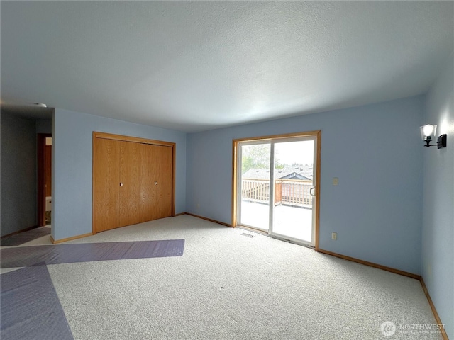 832 Whale Ct SW, Ocean Shores, WA 98569 - unfurnished bedroom featuring access to exterior, light carpet, and a closet