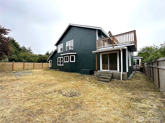 832 Whale Ct SW, Ocean Shores, WA 98569 - back of house with a balcony, entry steps, and a fenced backyard
