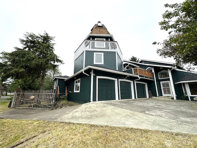832 Whale Ct SW, Ocean Shores, WA 98569 - view of front facade featuring a balcony, driveway, and a garage