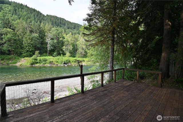 53009 S Riverside Rd, Gold Bar, WA 98251 - wooden deck featuring a wooded view and a water view