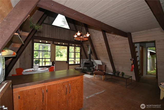 53009 S Riverside Rd, Gold Bar, WA 98251 - kitchen featuring a wood stove, wood walls, a chandelier, wood ceiling, and brown cabinets