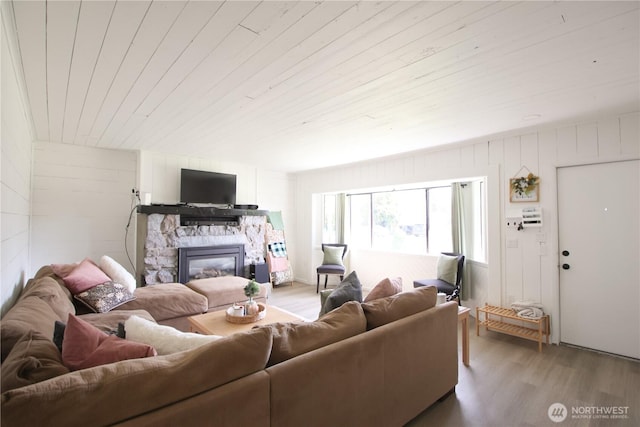 251 N 2nd St N, Buckley, WA 98321 - living room featuring wood finished floors, a stone fireplace, and wooden ceiling