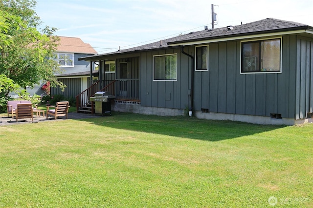 251 N 2nd St N, Buckley, WA 98321 - rear view of house featuring board and batten siding, a yard, and a shingled roof