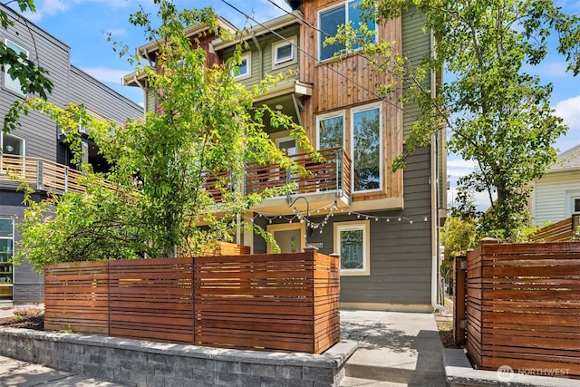 4220 Fremont Ave N Unit A, Seattle, WA 98103 - view of front of house with a balcony and a fenced front yard