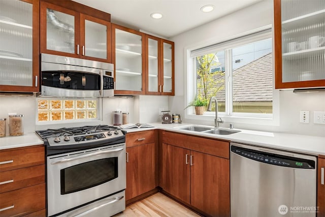 4220 Fremont Ave N Unit A, Seattle, WA 98103 - kitchen with appliances with stainless steel finishes, light countertops, glass insert cabinets, brown cabinets, and recessed lighting