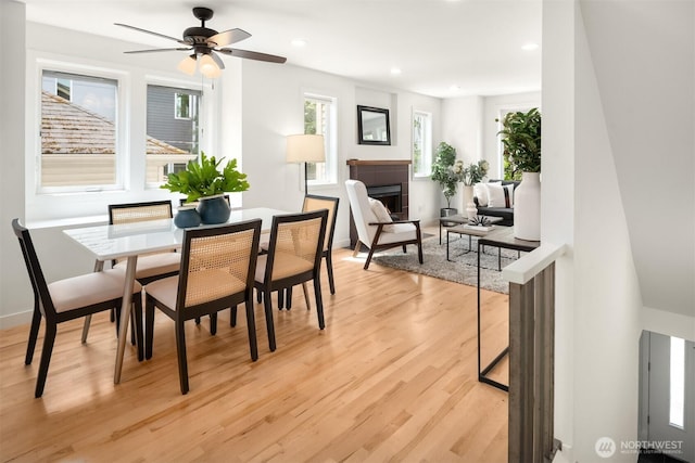 4220 Fremont Ave N Unit A, Seattle, WA 98103 - dining space with light wood-type flooring, a fireplace, a ceiling fan, and recessed lighting