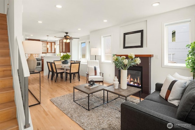 4220 Fremont Ave N Unit A, Seattle, WA 98103 - living room featuring stairway, a fireplace, light wood-style floors, a ceiling fan, and recessed lighting