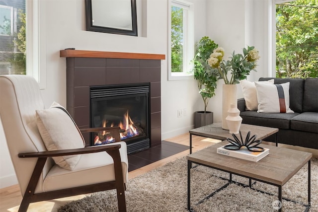4220 Fremont Ave N Unit A, Seattle, WA 98103 - living room with a tiled fireplace, plenty of natural light, and wood finished floors