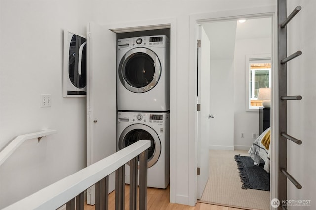 4220 Fremont Ave N Unit A, Seattle, WA 98103 - washroom featuring stacked washing machine and dryer and light wood-type flooring