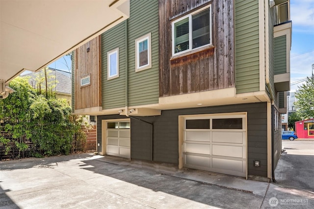 4220 Fremont Ave N Unit A, Seattle, WA 98103 - rear view of property featuring a garage and concrete driveway