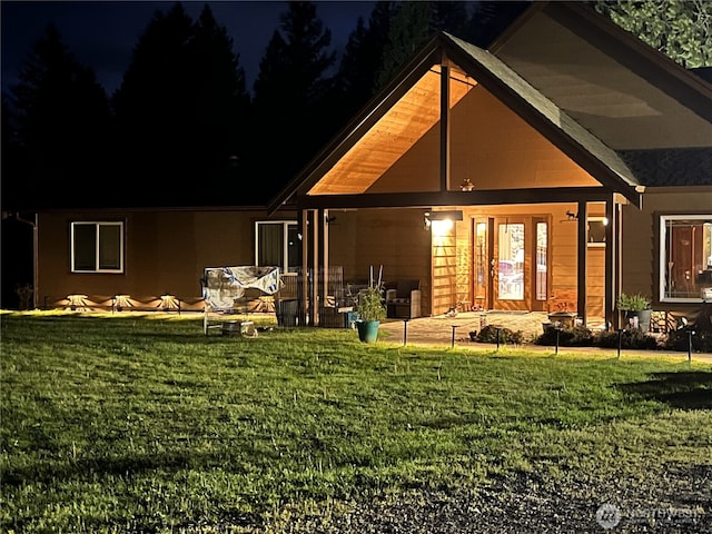 33320 27th Ave E, Roy, WA 98580 - back of house at night featuring a yard