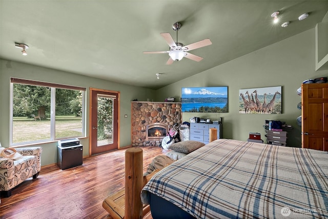 33320 27th Ave E, Roy, WA 98580 - bedroom featuring lofted ceiling, wood finished floors, access to outside, a stone fireplace, and a ceiling fan