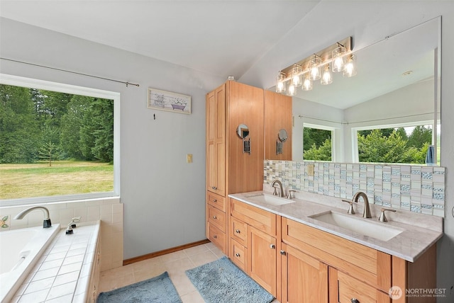 33320 27th Ave E, Roy, WA 98580 - full bath featuring vaulted ceiling, double vanity, a garden tub, tile patterned flooring, and decorative backsplash
