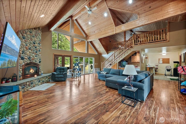33320 27th Ave E, Roy, WA 98580 - living area with high vaulted ceiling, hardwood / wood-style flooring, a ceiling fan, stairs, and a stone fireplace