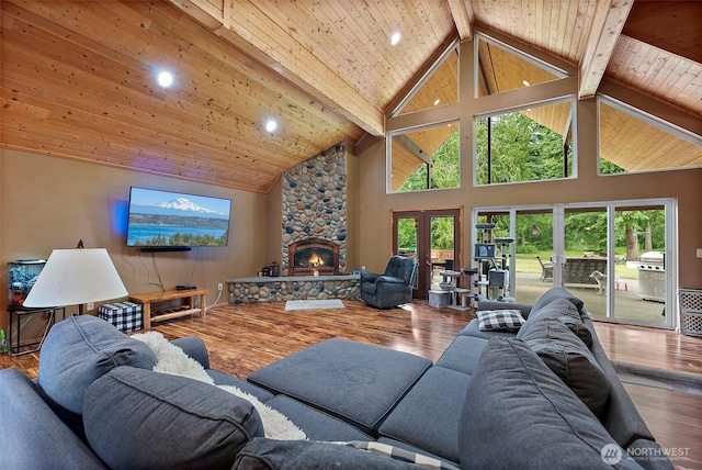 33320 27th Ave E, Roy, WA 98580 - living area with a stone fireplace, high vaulted ceiling, a wooden ceiling with exposed beams, recessed lighting, and wood finished floors