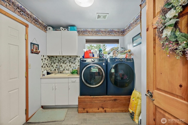 33320 27th Ave E, Roy, WA 98580 - laundry area featuring washer and clothes dryer, cabinet space, and light wood finished floors