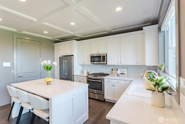 1818 36th St, Bellingham, WA 98226 - kitchen featuring appliances with stainless steel finishes, decorative backsplash, a kitchen island, white cabinets, and recessed lighting