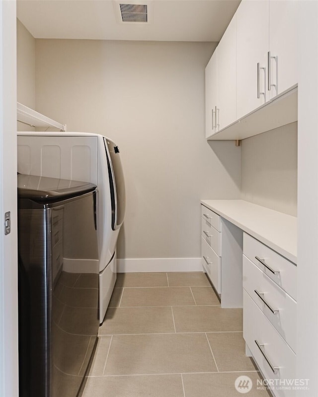 1818 36th St, Bellingham, WA 98226 - washroom featuring cabinet space, light tile patterned flooring, and washing machine and clothes dryer