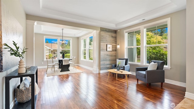 4597 Rutherford Cir SW, Port Orchard, WA 98367 - sitting room featuring a tray ceiling, decorative columns, wood-type flooring, and ornamental molding
