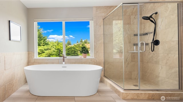 4597 Rutherford Cir SW, Port Orchard, WA 98367 - bathroom featuring a freestanding tub, a stall shower, and tile walls