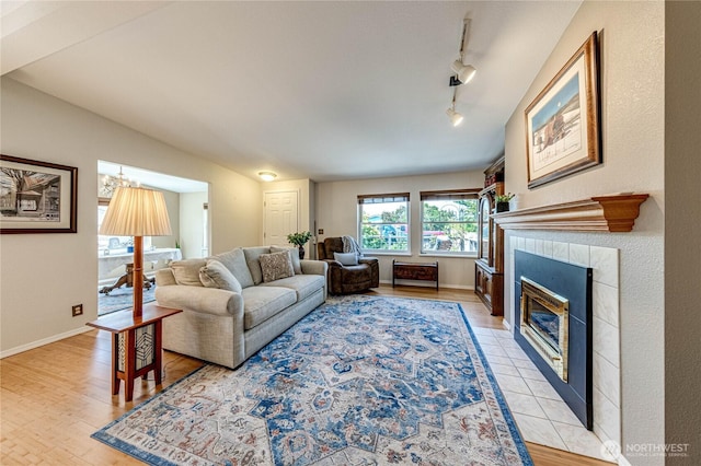 629 N 7th Ave, Sequim, WA 98382 - living room featuring a tiled fireplace, track lighting, and light wood finished floors