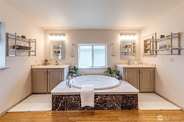 629 N 7th Ave, Sequim, WA 98382 - full bathroom featuring wood finished floors, a bath, and two vanities