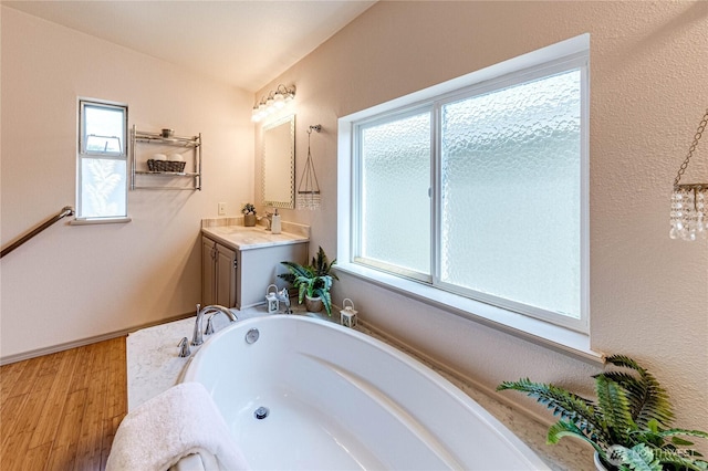 629 N 7th Ave, Sequim, WA 98382 - bathroom featuring a garden tub, vanity, and wood finished floors