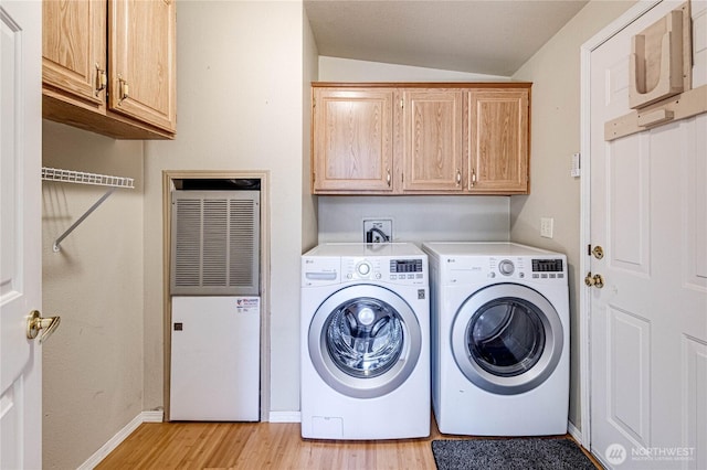629 N 7th Ave, Sequim, WA 98382 - washroom featuring a heating unit, cabinet space, washing machine and dryer, and light wood finished floors