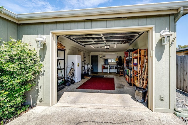 629 N 7th Ave, Sequim, WA 98382 - garage featuring freestanding refrigerator and a garage door opener