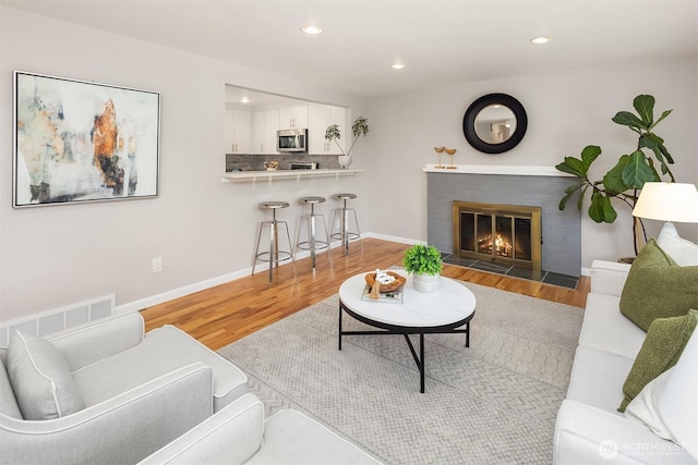 16011 Sunnyside Ave N, Shoreline, WA 98133 - living room featuring wood finished floors, a fireplace, and recessed lighting