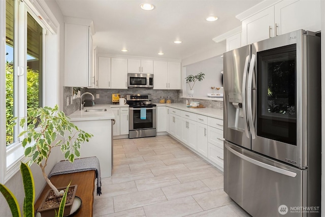 16011 Sunnyside Ave N, Shoreline, WA 98133 - kitchen featuring stainless steel appliances, decorative backsplash, light countertops, white cabinetry, and recessed lighting