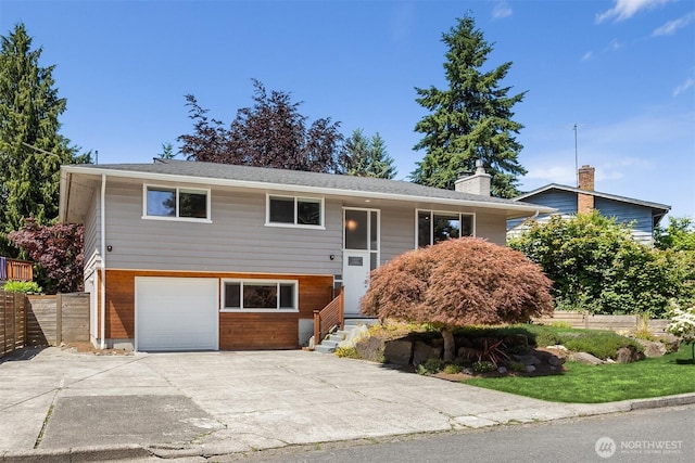 16011 Sunnyside Ave N, Shoreline, WA 98133 - split foyer home with driveway, an attached garage, and a chimney