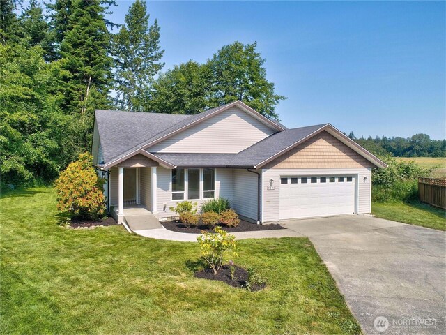 8391 Richmond Park Rd, Birch Bay, WA 98230 - view of front facade with a garage, concrete driveway, roof with shingles, and covered porch